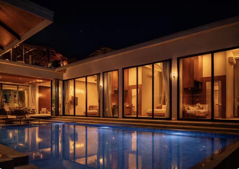 VIP luxury villa with private pool lit up at night